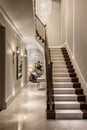 Luxury living room interior design in classic style with marble carrara tiles, dark and white stairs. Apartment or hotel concept Royalty Free Stock Photo