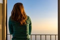 Amalfi - Woman enjoying a warm sunset at the Amalfi Coast in Italy from her hotel window