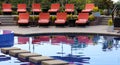 Luxury lounge chairs at Costa Rican premium travel hotel poolside. Royalty Free Stock Photo