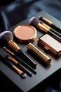 Luxury Makeup Brushes And Elegant Cosmetic Compacts Arranged On A Black Satin Studio Surface Royalty Free Stock Photo