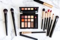 Luxury makeup set on marble table: brushes, lipsticks, and eyeshadows for a chic look Royalty Free Stock Photo