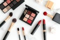 Luxury makeup set on marble table: brushes, lipsticks, and eyeshadows for a chic look Royalty Free Stock Photo