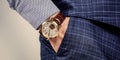 Luxury male wrist watch worn on arm in trousers pocket, time Royalty Free Stock Photo
