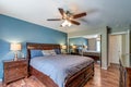 Luxury master bedroom primary bed room large bed ceiling fan blue wall real estate Royalty Free Stock Photo