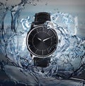 Luxury men`s watch in water splashes demonstrating its waterproof Royalty Free Stock Photo