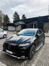 Luxury Mercedes-Benz EQS car parked outdoors with modern building in background