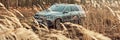 Luxury Mercedes GLE with 4x4 drive on the off-road. V6 engine, 367 hp.The car is on the road partially covered by grasses. There