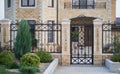 luxury metal forged front door and fence in a private house