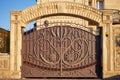 Luxury metal wrought iron gates and a stone arch for the entrance to a private house
