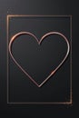 A minimalist artwork featuring a rose gold metallic heart within a glowing square frame, against a dark background. Royalty Free Stock Photo