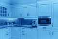 Luxury modern beige and white kitchen interior in classic blue color. Royalty Free Stock Photo