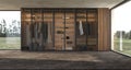 Luxury modern interior design large wooden wardrobe with clothes hanging on rail in walk in closet and shelf lighting Royalty Free Stock Photo