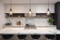 Luxury, modern kitchen interior with white marble carrara countertops, black stools and ovens