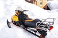 snowmobile scooter vehicle parked on snow in mountains road in cold winter day.rental automobile extreme sport