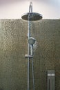 Luxury modern stainless steel ceiling rain shower, Shower head faucet and holder in bathroom on golden decorating tiles wall backg Royalty Free Stock Photo