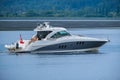 Luxury motor yacht in navigation. White and blue luxury yacht in motion. Modern powerboat speeding on the sea