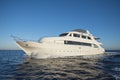 Luxury motor yacht sailing out on tropcial sea Royalty Free Stock Photo