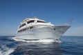 Luxury motor yacht sailing out on tropcial sea Royalty Free Stock Photo