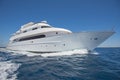 Luxury motor yacht sailing out on tropcial sea Royalty Free Stock Photo