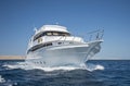 Luxury motor yacht sailing out on tropcial sea Royalty Free Stock Photo