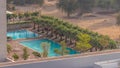 Luxury outdoor swimming pool and relaxing zone around aerial timelapse