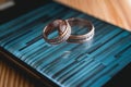 Luxury pair of wedding golden rings on a smartphone