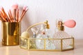 Luxury perfumes and makeup brushes on dressing table Royalty Free Stock Photo