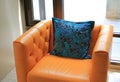 Luxury pillows on the orange leather sofa Royalty Free Stock Photo
