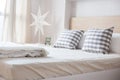 Luxury pillows on white bed in bedroom Royalty Free Stock Photo