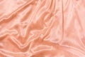 Luxury pink or pink gold silk background. Rippled silk fabric, drapery cloth, or satin texture Royalty Free Stock Photo