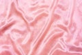 Luxury pink or pink gold silk background. Rippled silk fabric, drapery cloth, or satin texture Royalty Free Stock Photo