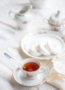 Luxury porcelain tea set with a cup, teapot, sugar bowl on white