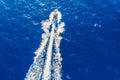 Luxury private speed motor boat leaving blue sea. Aerial top view Royalty Free Stock Photo