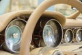 Luxury Race Retro Car Interior With Beige Finish. Speedometer And Tachometer On Dashboard. Car In Workshop