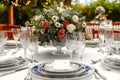 Luxury reception beautiful flowers, serving dishes, glasses on adorned table Royalty Free Stock Photo