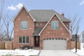 A luxury red brick, two story home in the winter. Royalty Free Stock Photo