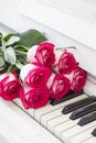Luxury red roses on a piano. Bouquet of red roses and piano Royalty Free Stock Photo