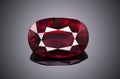Luxury red transparent sparkling gemstone shape oval cut ruby isolated on grey background