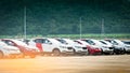 Luxury red and white new suv car parked on concrete parking area at factory near mountain. Car stock for sale. Car factory parking Royalty Free Stock Photo