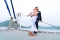 Luxury relaxing couple traveler in nice dress and suite stand at part of cruise yacht with background of water sea and white sky.