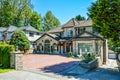 Luxury residential house with garage on back yard and tile paved front yard Royalty Free Stock Photo