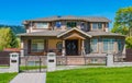 Luxury residential house with metal fence and green lawn in front Royalty Free Stock Photo