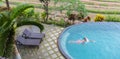 Luxury Resort. Man Relaxing In Infinity Swimming Pool Water. Beautiful Happy Healthy Male Model Enjoying Summer Travel Royalty Free Stock Photo