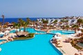 Luxury resort pool with palm trees. Royalty Free Stock Photo