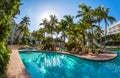 Luxury resort pool with palm trees. Royalty Free Stock Photo