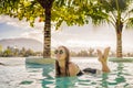 Luxury resort swimming pool. Beautiful woman tourist relaxing in holiday retreat on summer travel vacation. Bikini girl Royalty Free Stock Photo