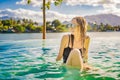 Luxury resort swimming pool. Beautiful woman tourist relaxing in holiday retreat on summer travel vacation. Bikini girl Royalty Free Stock Photo