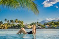 Luxury resort swimming pool. Beautiful woman tourist relaxing in holiday retreat on summer travel vacation. Bikini girl Royalty Free Stock Photo