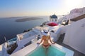 Luxury resort vacation bikini model woman relaxing lying down by hot tub jacuzzi private swimming pool hotel room suite balcony Royalty Free Stock Photo