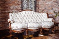 Luxury rich living room design with elegant classic sofa and old red brick wall Royalty Free Stock Photo